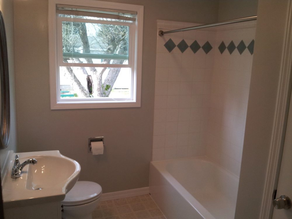 Finished bathroom remodel with tile tub surround